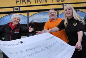 Adrian and Emma Crick of The Firk Inn hand over cheque to Jean Dixon from Yorkshire Air Ambulance.