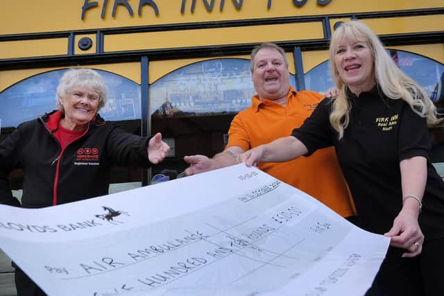 Adrian and Emma Crick of The Firk Inn hand over cheque to Jean Dixon from Yorkshire Air Ambulance.