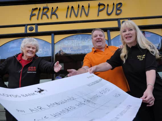 Adrian and Emma Crick of The Firk Inn hand over cheque to Jean Dixon from Yorkshire Air Ambulance.