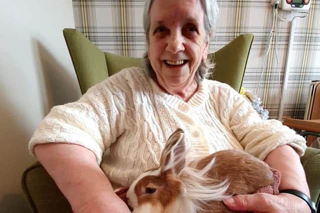 Scarborough Hall resident Sheila Deere with a pet rabbit