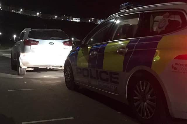 The white Kia stopped by police