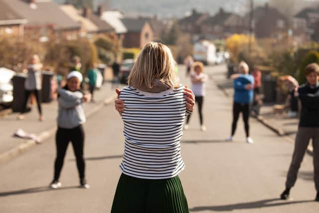 Charlotte Armitage leading dance sessions for her neighbours.