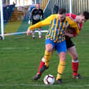 ON THE BALL: Seamer’s Ricky Greening fends off a Filey defender. Picture by Richard Ponter.