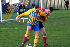 ON THE BALL: Seamer’s Ricky Greening fends off a Filey defender. Picture by Richard Ponter.