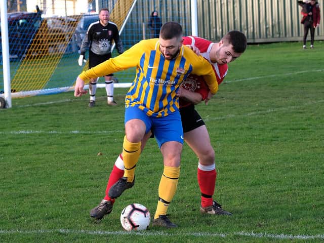 ON THE BALL: Seamer’s Ricky Greening fends off a Filey defender. Picture by Richard Ponter.