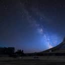 Vibrant Milky Way over the landscape of Norber Ridge and stone barn in the Yorkshire Dales National Park.