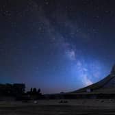 Vibrant Milky Way over the landscape of Norber Ridge and stone barn in the Yorkshire Dales National Park.