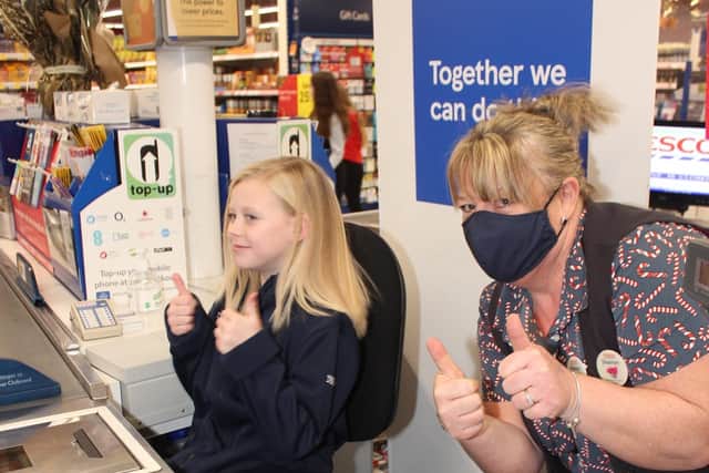Ruby scanning her chocolate through the tills.