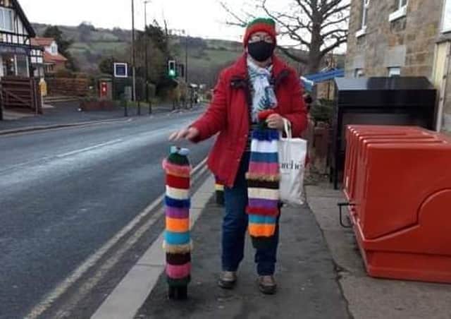 Sandra Young, the Sleights Spar store supervisor, is pictured next to the decorated bollards.