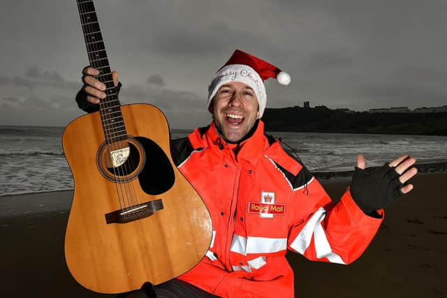 Singing Postman Luke and his guitar on North Bay.