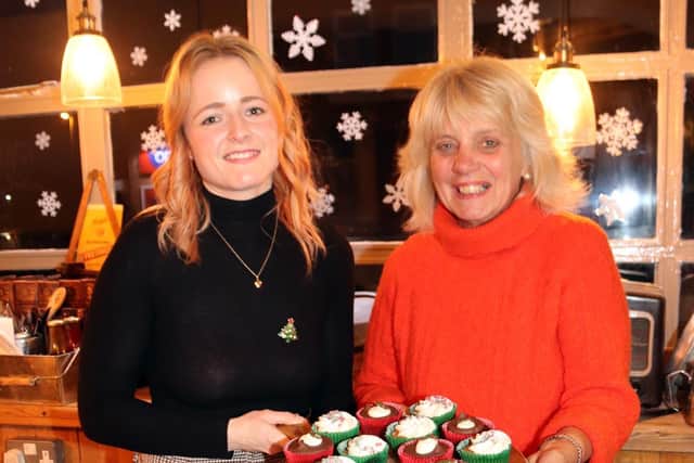 Hideout Assistant Manager Toni Bethany-Hall and volunteer Jill Heaps serving at the cake table last year.