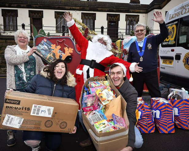 Courtney Richardsonand Joe Maw deliver gifts to the Rainbow Centre,pictured with Trish Kinsella of the Rainbow Centre assisted by Santa and Lions
President Rob Hunter
