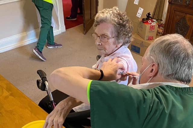 Joyce Allen, a resident at The Hall care home, is given her vaccine.