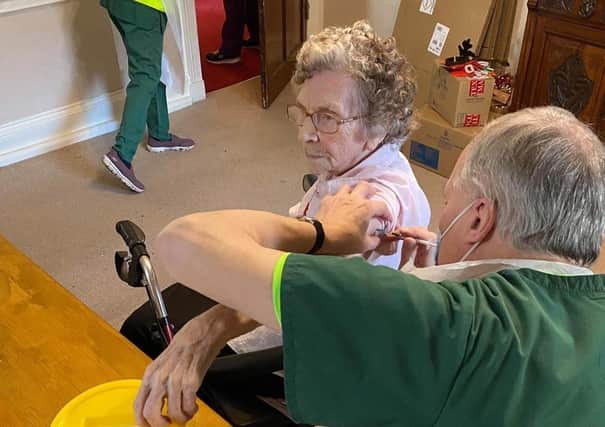 Joyce Allen, a resident at The Hall care home, is given her vaccine.