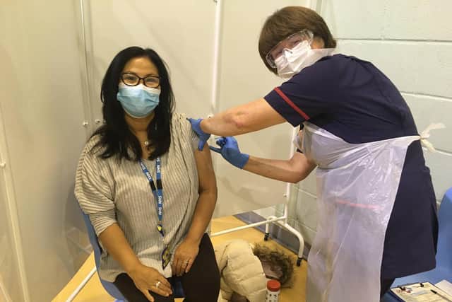 Elizabeth Lowery, Medical Lab Assistant, being vaccinated by Carol Halton, Matron.