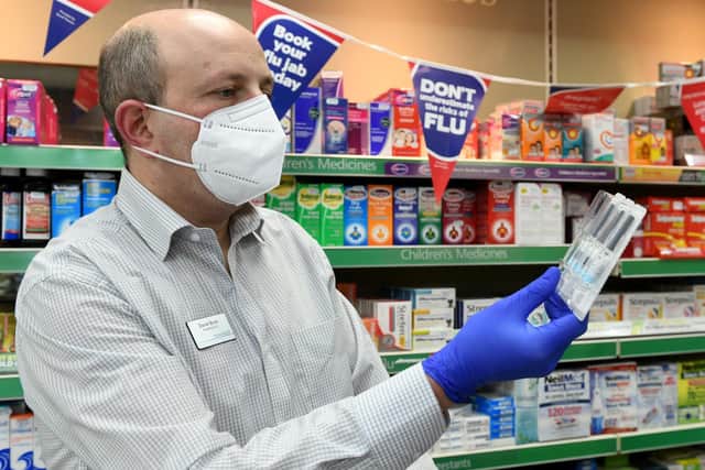 Pharmacist Daniel Brash checking their supply of flu vaccines at Mitchell's Chemist in Horsforth, Leeds. Photo: Gary Longbottom