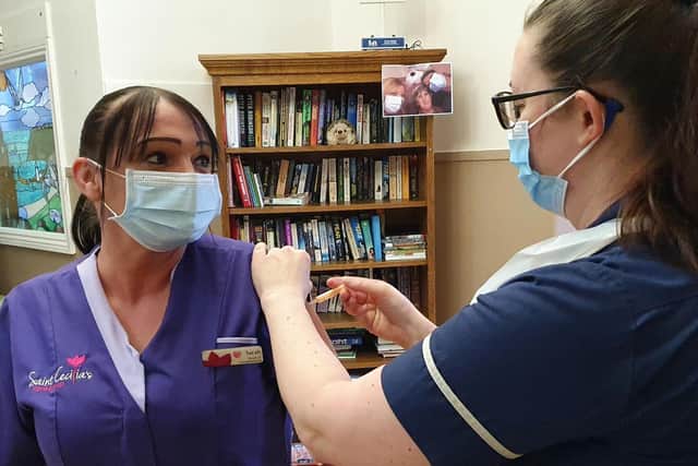 Sarah Earp, Housekeeper at Saint Cecilia’s Nursing Home receives her vaccination.