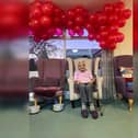 Sylvia surrounded by 99 red balloons on her birthday last year.
