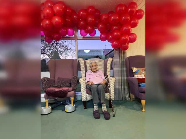 Sylvia surrounded by 99 red balloons on her birthday last year.