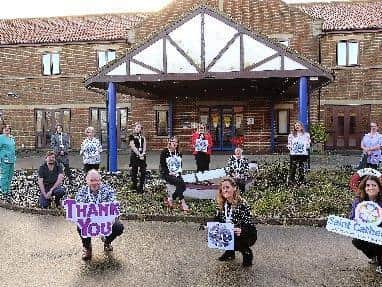St Catherine's Hospice Staff say thank you for hitting their Helping Hand target ... Front, Chief Executive Mike Wilkerson, Susan Stephenson and Tracy Calcraft.
