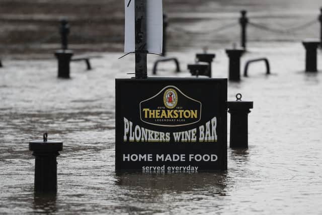 Flood water rises up a sign outside a pub in York as Storm Christoph is set to bring widespread flooding, gales and snow to parts of the UK. Photo: PA