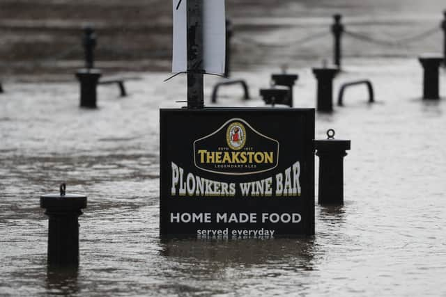 Flood water rises up a sign outside a pub in York as Storm Christoph is set to bring widespread flooding, gales and snow to parts of the UK. Photo: PA