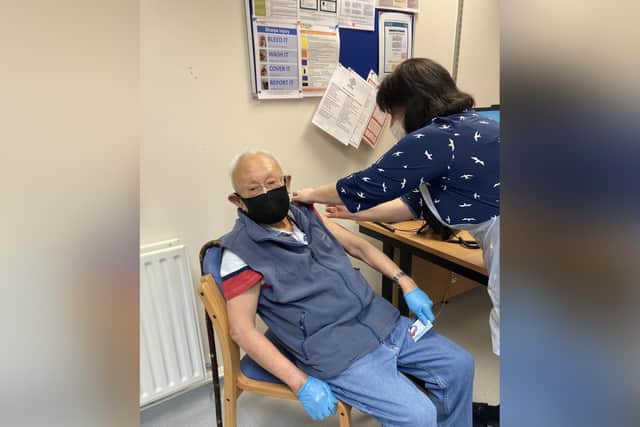 Retired Central Healthcare GP 85-year-old Ronnie Kok receiving his coronavirus vaccine.