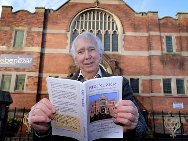 Author Sam Cowgill with a copy of his book.
