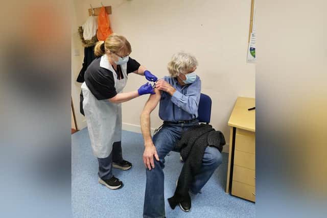 Jeannette, a specialist nurse, giving a patient his COVID vaccine.