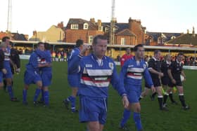 Whitby Town skipper Dave Logan leads his side off after a memorable FA Cup win for the Blues against rivals Scarborough FC in 2001/02