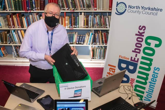Mark Glossop from Scarborough library with dropped-off laptops and the Reboot North Yorkshire website.