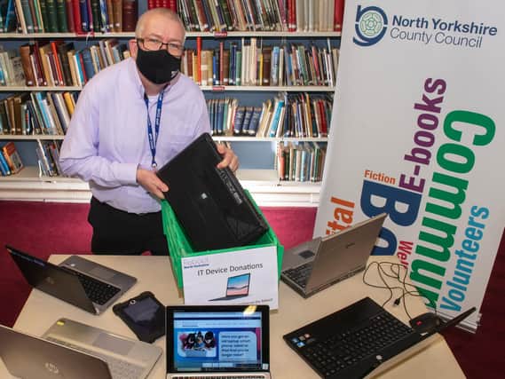 Mark Glossop from Scarborough library with dropped-off laptops and the Reboot North Yorkshire website.