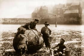 Mudlarks, children who beachcomb for waste materials to resell, on Tate Hill Sands, Whitby, North Yorkshire.