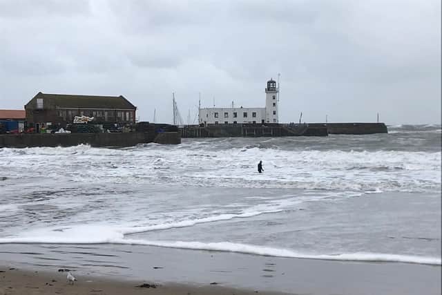 The man, in a wetsuit, was in the sea near the lifeboat station.