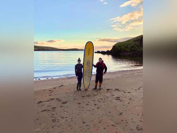 Stephanie Riise and Jake Anderson find Michael Brogan's surfboard washed up on the beach in Shetland - 400 miles from its home!