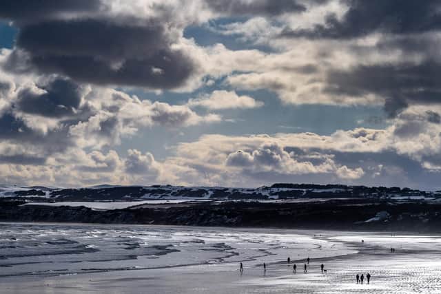 Members of the public brave the cold on Filey Beach.