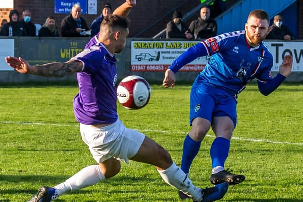 Mackenzie Heaney gets a shot away for Whitby Town