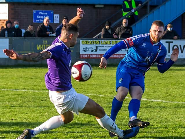 Mackenzie Heaney gets a shot away for Whitby Town