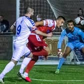 DERBY DELIGHT: Will Thornton fends off Whitby Town striker Brad Fewster during Boro’s derby victory at the Flamingo Land Stadium