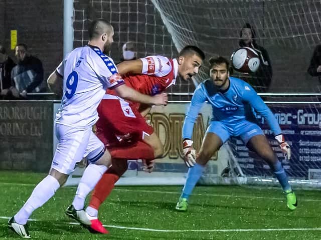 DERBY DELIGHT: Will Thornton fends off Whitby Town striker Brad Fewster during Boro’s derby victory at the Flamingo Land Stadium