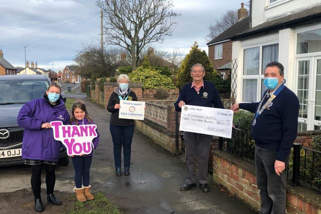 Pictured left to right: Emma Wilson and her daughter Molly (age 7) representing Saint Catherine’s, Lions vice president Brenda Casey, Lion Peter Hawkins and president John Sellers.