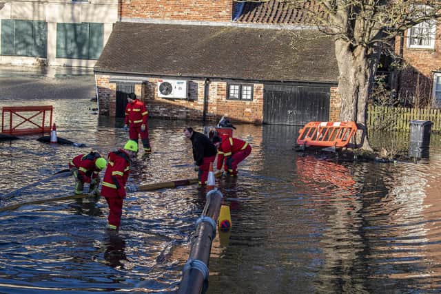 Fire crews pump out flood water in Malton back into the River Derwent.