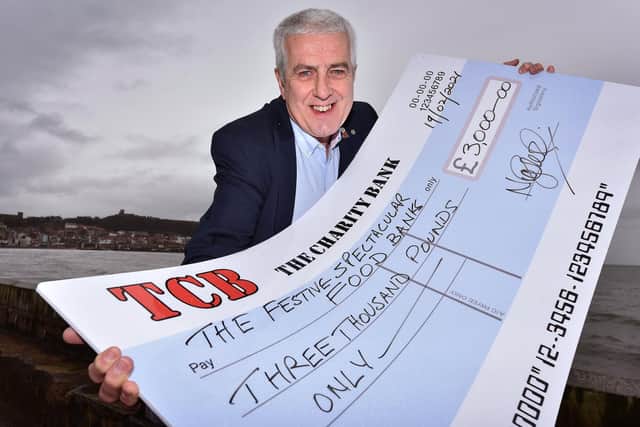 Organizer Nigel Wood presented the cheque to the charities.