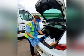 A county council driver prepares to deliver tests for a care sector satellite testing unit.