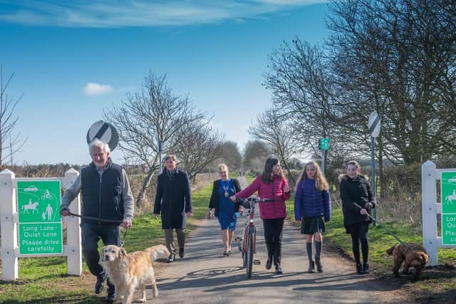 From left, County Councillor David Jeffels, Headteacher Jonathan Wanless, Parish Council Chairman Councillor Lynda Wallis and Seamer & Irton Community Primary School pupils from the same ‘bubble’ walking on Long Lane.