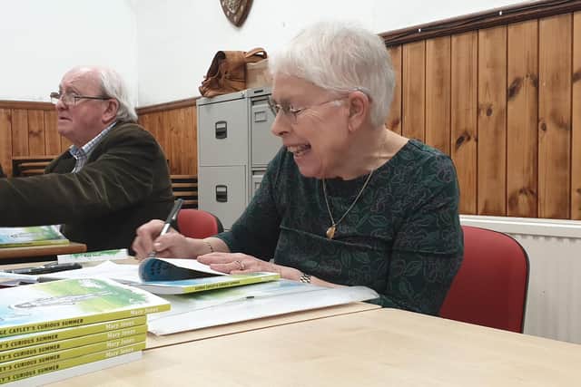 Mary Jones signing copies of her new book.