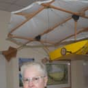 Mary Jones with a model replica of Cayley's flying machine.