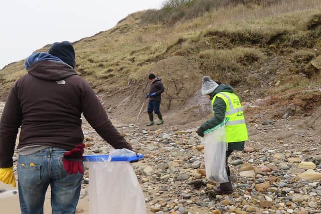 Cleaning the beach at Filey.