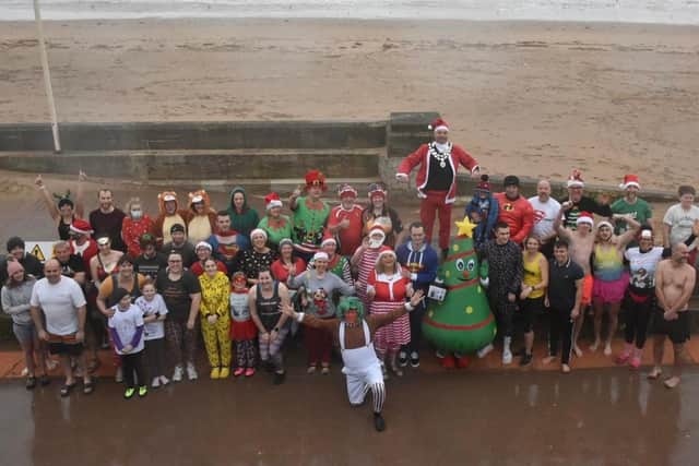 A group of hardy Boxing Day dippers pose for a photo near Richies Cafe Bar. Image courtesy of TCF Photography