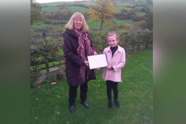 Eskdaleside-cum-Ugglebarnby Parish Council's Young Person of the Year Award presented to Evie Hodgson, 9, of Sleights, by Vice Chairman Cllr L Jones.